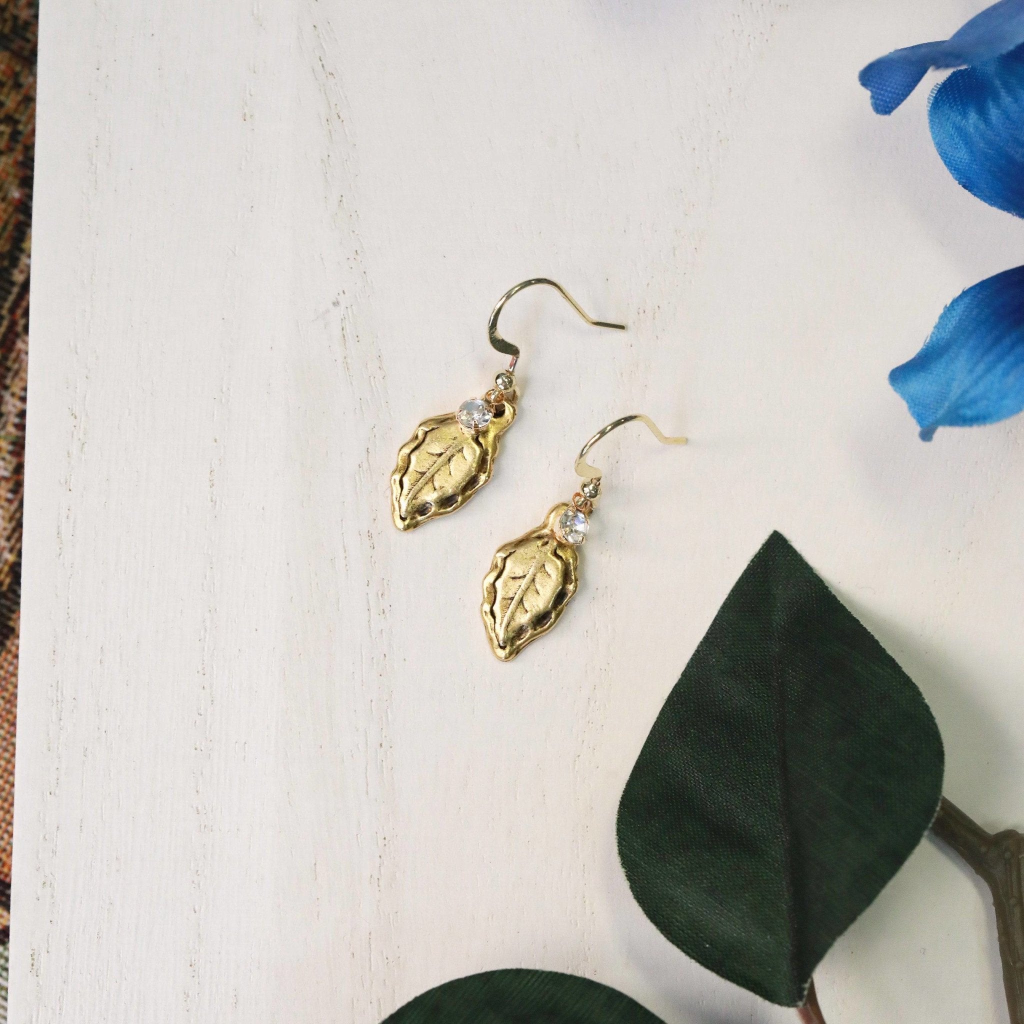 forest leaf charm earrings in gold with crystal charm top view