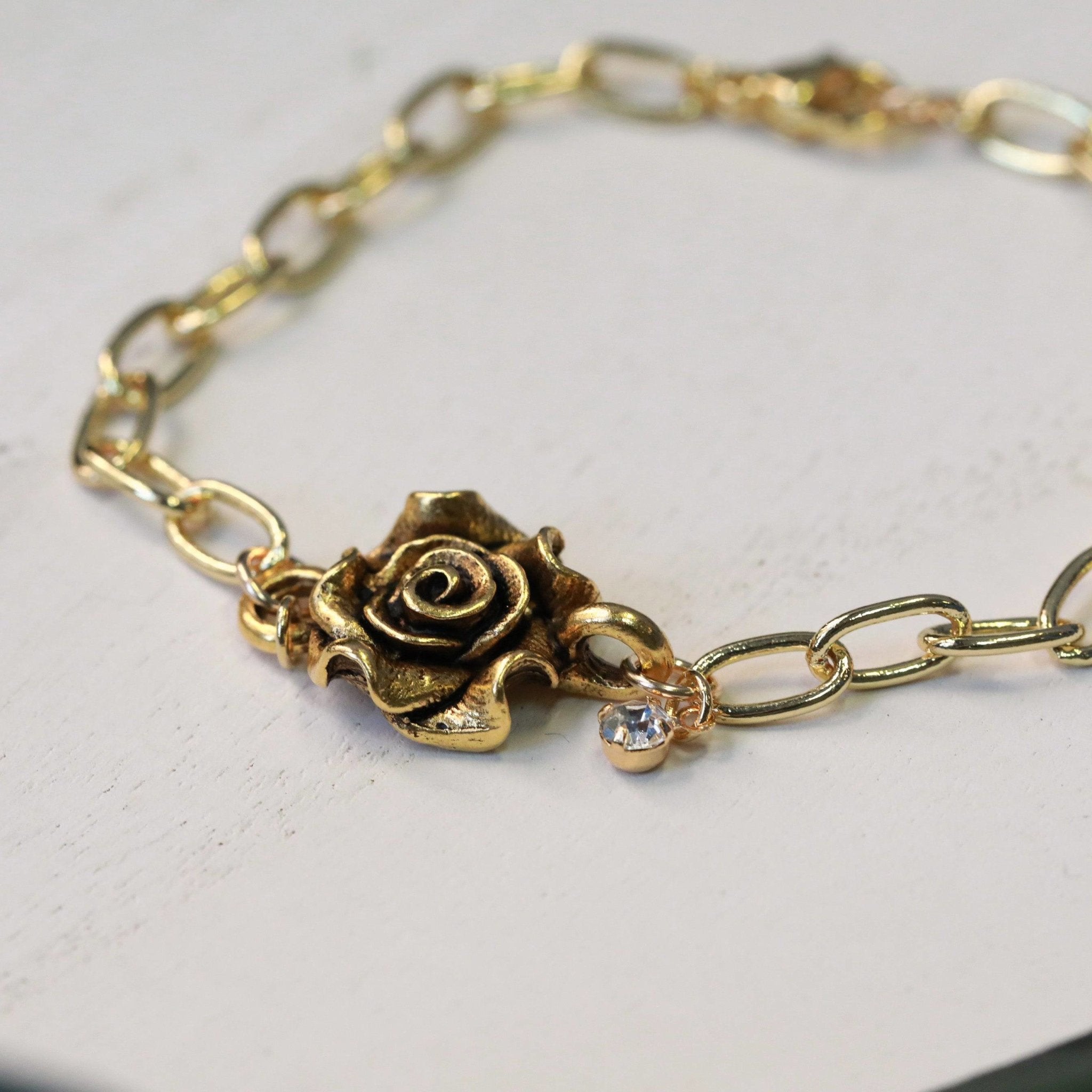 gold rose connector bracelet with crystal charm on gold plated chain