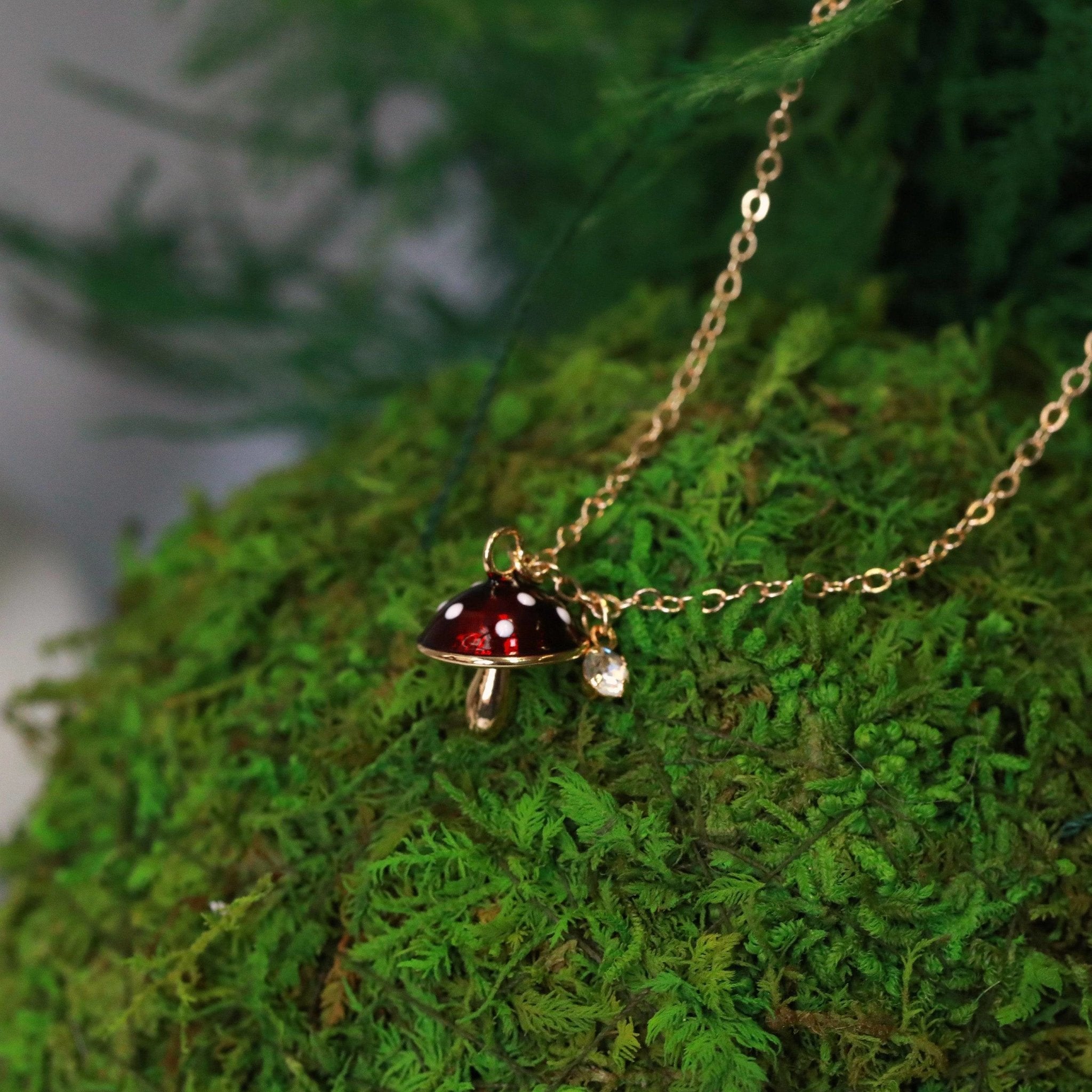 tiny mushroom charm earrings in red with white dots on 14kt gold filled earring hooks with tiny crystal charms matching necklace