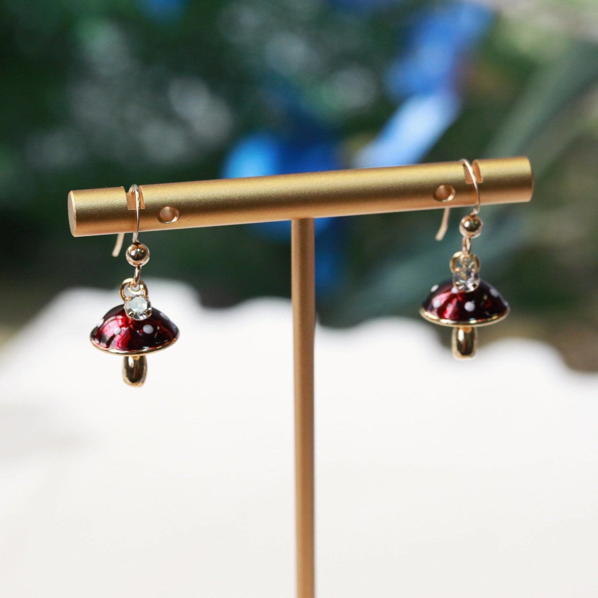 tiny mushroom charm earrings in red with white dots on 14kt gold filled earring hooks with tiny crystal charms