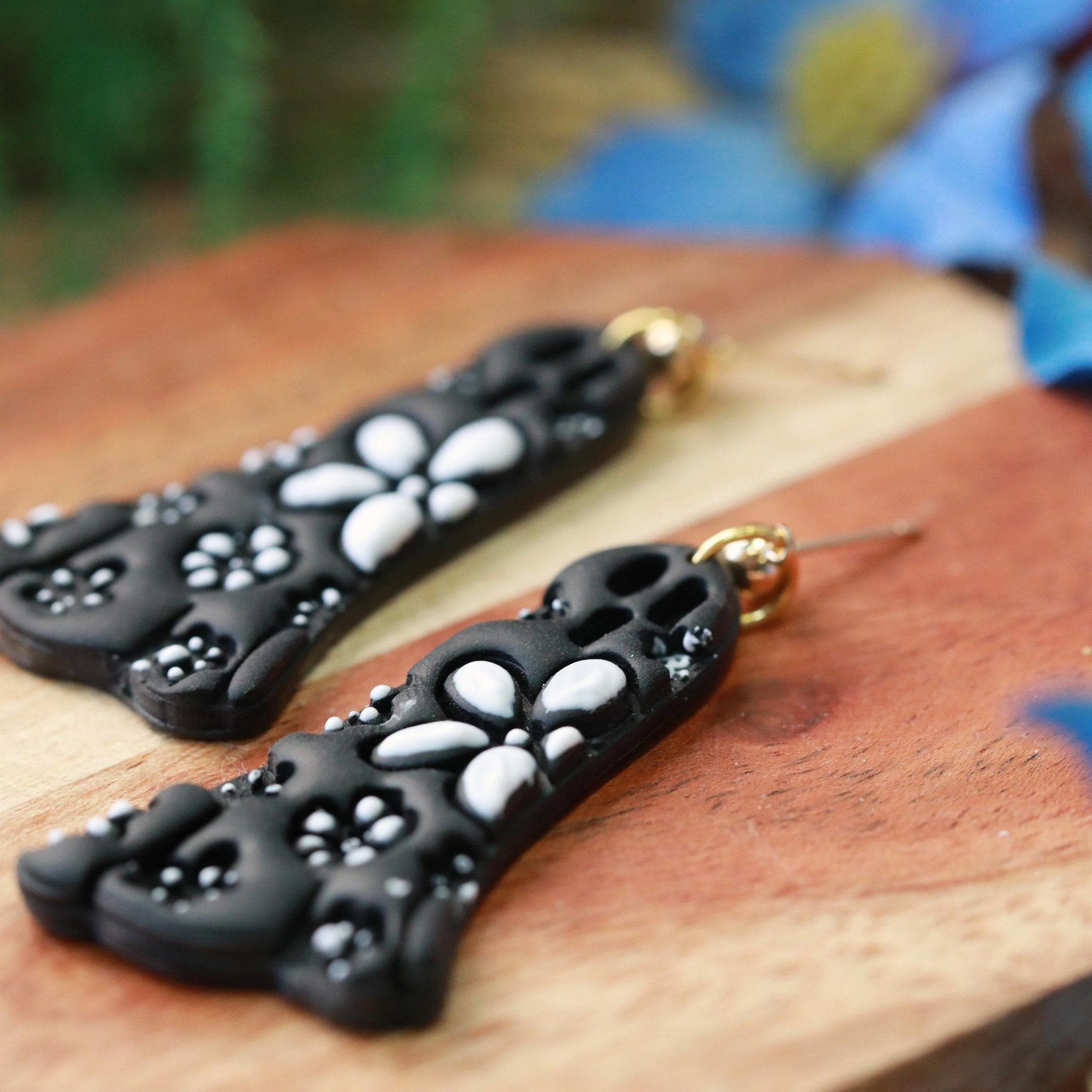 daisy ghost clay earrings in black and white by everything ky and i black closeup