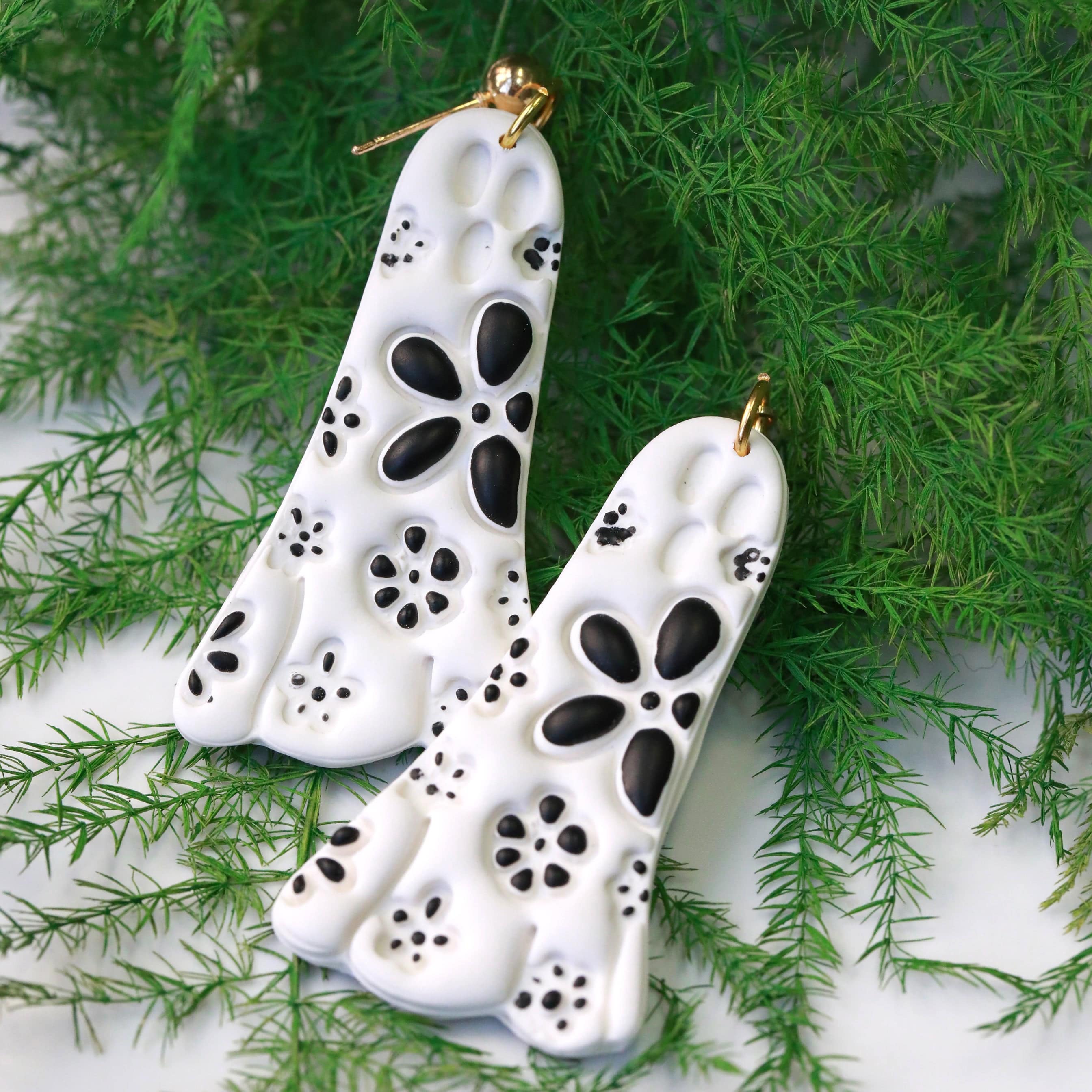 daisy ghost clay earrings in black and white by everything ky and i white on green